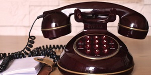 A photograph of a vintage telephone placed on a table